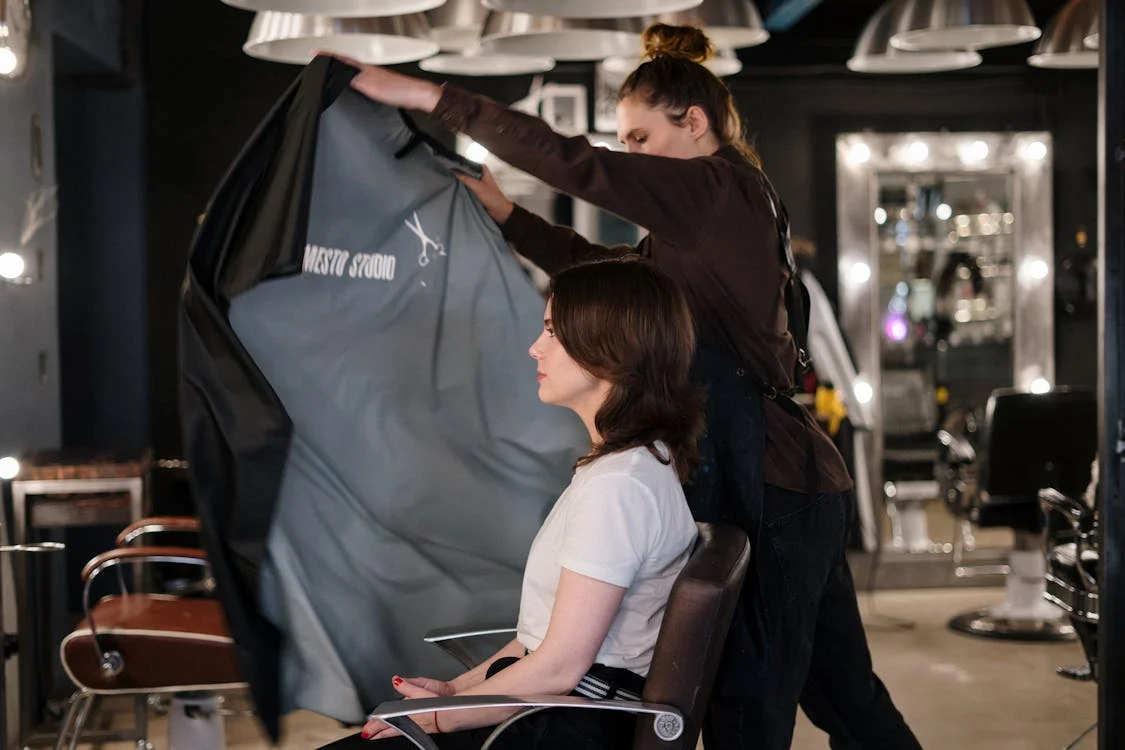 a female customer about to have her haircut