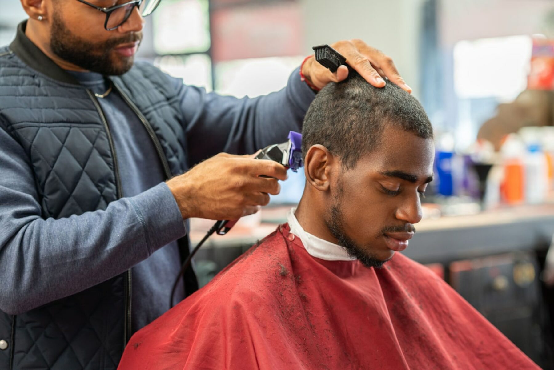Man doing hair cut at barber shop
